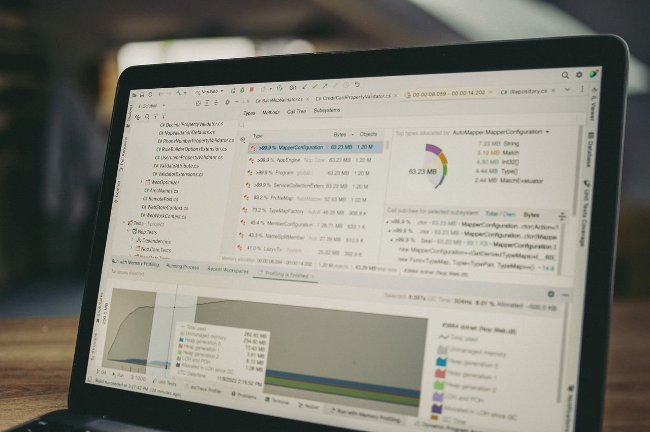A close-up view of a laptop screen showing a coding and data analysis software interface in an indoor setting.